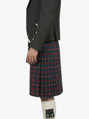 Person wearing a dark gray jacket and red plaid kilt on a white background
