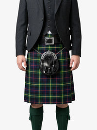 Person wearing a traditional Scottish kilt with a tartan pattern on a white background
