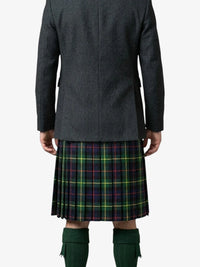 Person wearing a dark gray coat and a plaid kilt on a white background