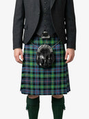 Person wearing a traditional Scottish kilt with a tartan pattern on a white background