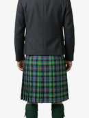 Person wearing a dark jacket and green plaid kilt on a white background