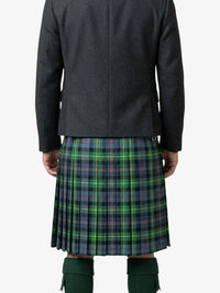 Person wearing a dark jacket and green plaid kilt on a white background