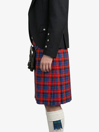 Person wearing a black jacket and red plaid kilt on a white background