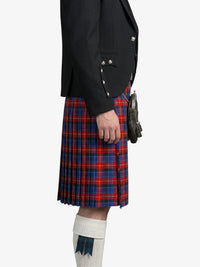 Person wearing a black jacket and red plaid kilt on a white background