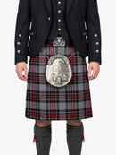 Person wearing a traditional Scottish kilt with a sporran on a white background