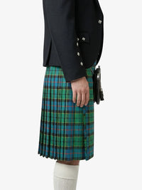 Person wearing a black jacket and green plaid kilt on a white background