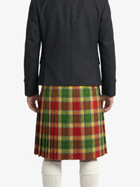 Person wearing a black jacket and a red, green, and brown plaid kilt on a white background