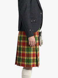 Person wearing a dark gray jacket and a red, green, and yellow plaid kilt on a white background