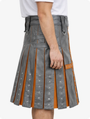 Gray kilt with orange lining worn by a person on a white background