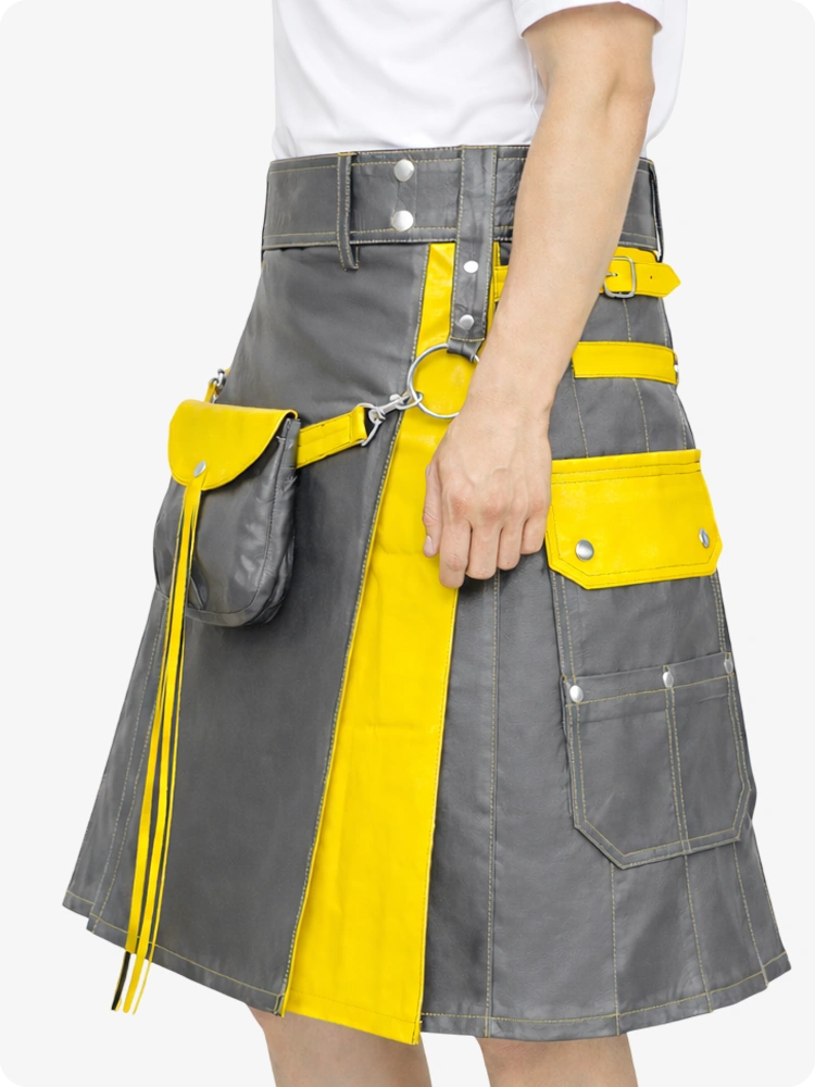 Gray and yellow kilt worn by a person on a white background