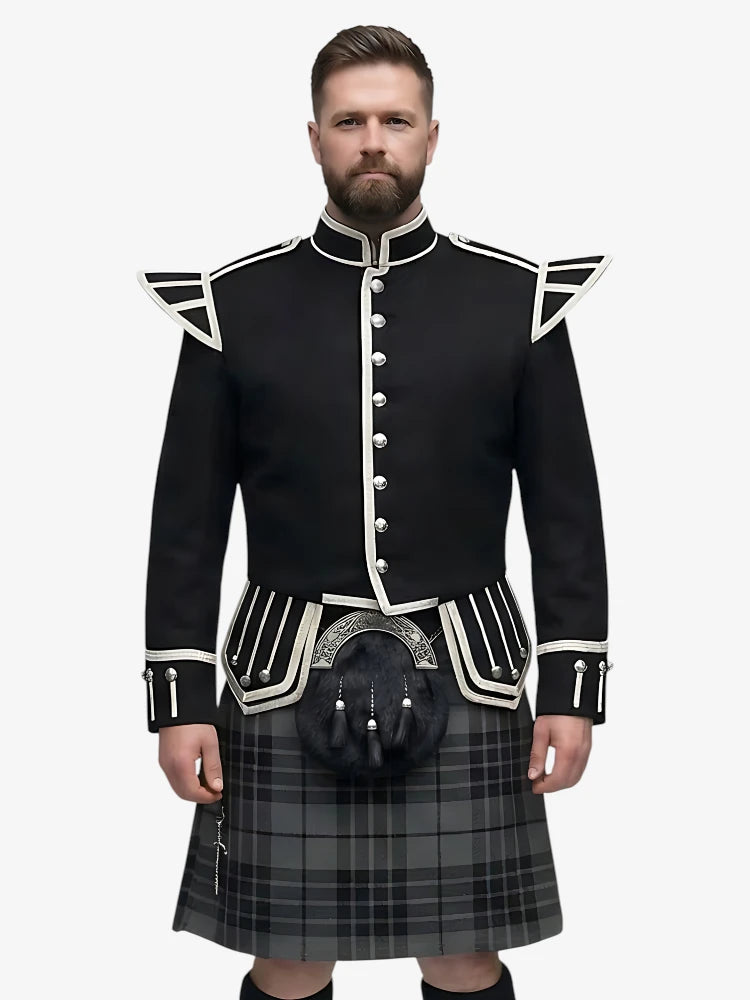 Man wearing a black doublet highland dress with white trim on a grey background