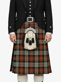 Person wearing a traditional Scottish kilt with a tartan pattern on a white background