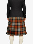 Person wearing a black jacket and plaid kilt on a white background