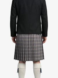 Person wearing a black coat and plaid kilt on a white background