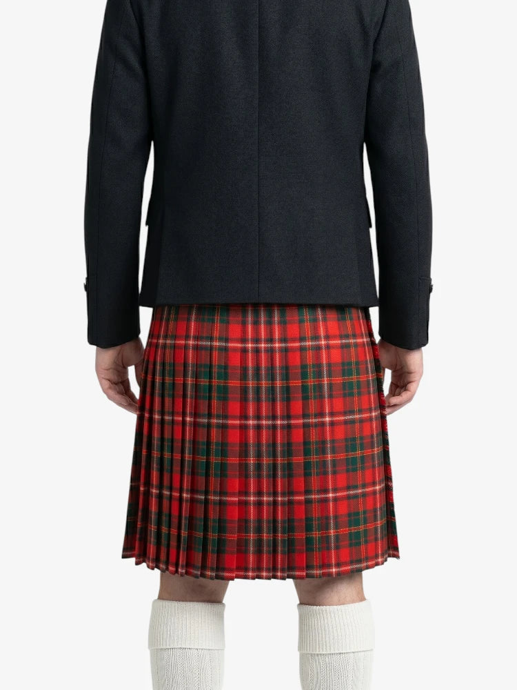 Person wearing a black coat and red plaid kilt on a white background