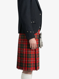 Person wearing a black jacket and red plaid kilt on a white background