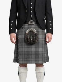 Person wearing a traditional Scottish kilt with a sporran on a white background