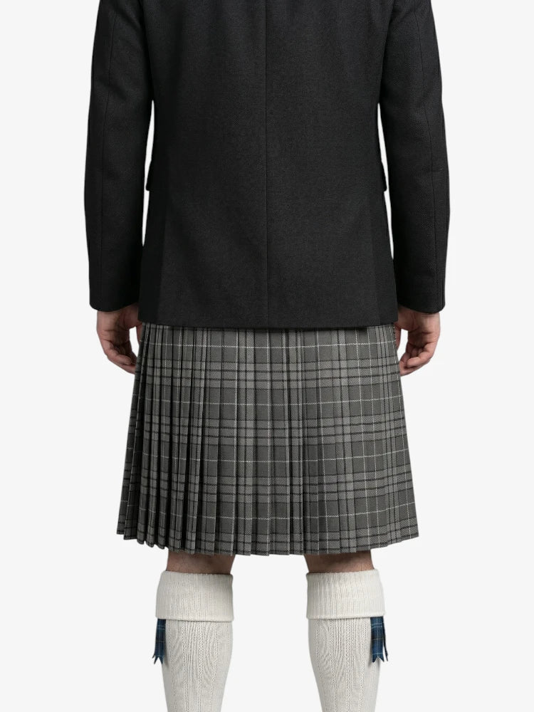 Person wearing a black coat and plaid kilt on a white background