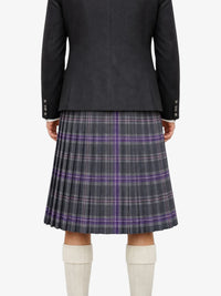 Person wearing a dark gray jacket and plaid kilt  on a white background