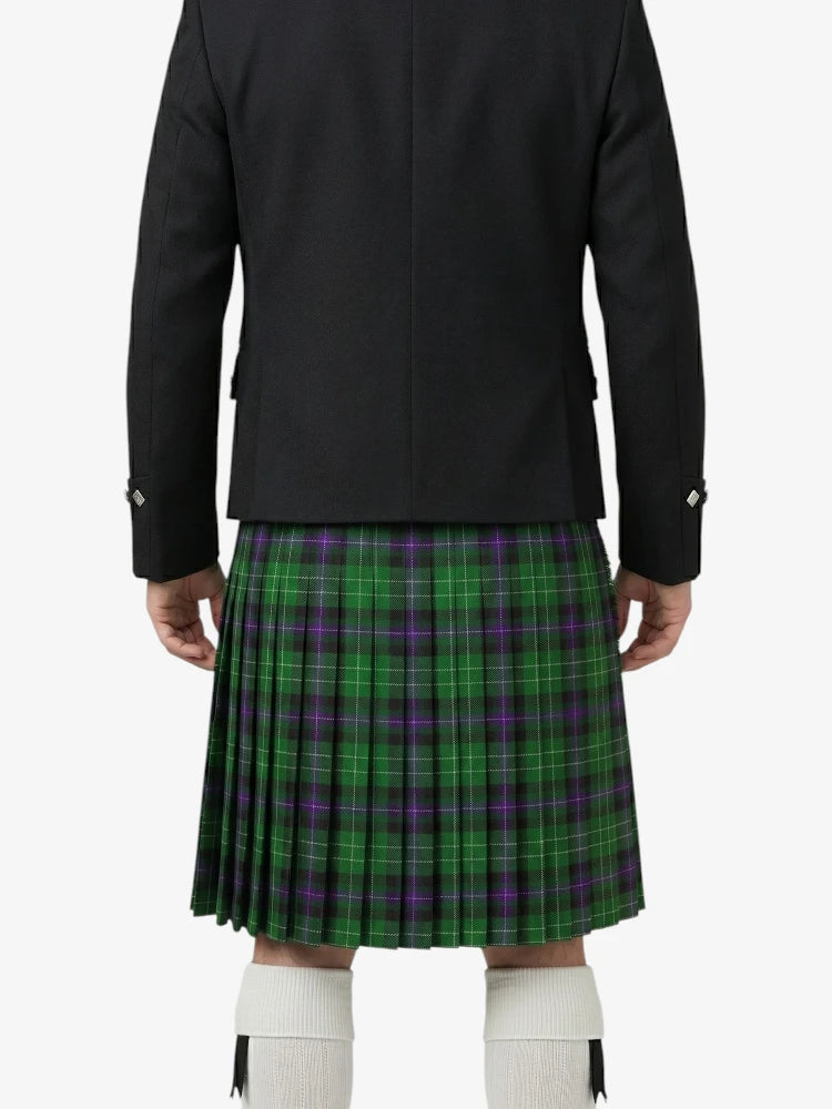 Person wearing a black jacket and green plaid kilt on a white background