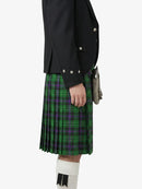 Person wearing a black jacket and green plaid kilt on a white background