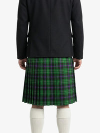 Person wearing a black coat and green plaid kilt on a white background