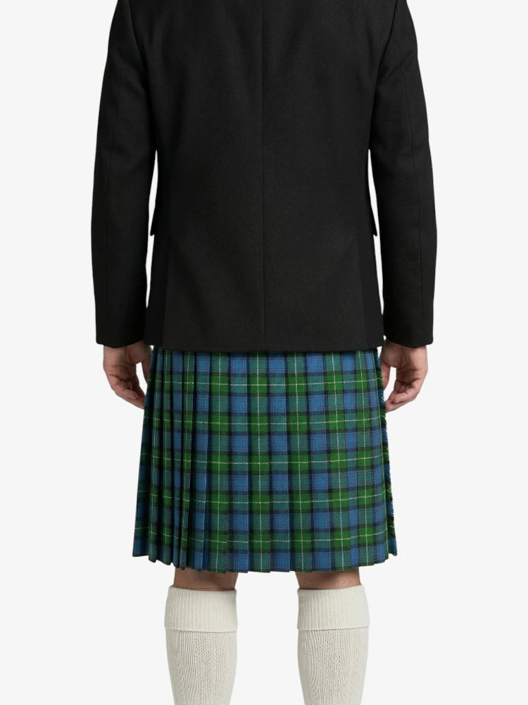 Person wearing a black coat and blue plaid kilt on a white background