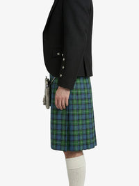 Person wearing a black jacket and green plaid kilt on a white background