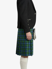 Person wearing a black blazer and blue plaid kilt on a white background