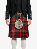 Person wearing a traditional Scottish kilt with a sporran on a white background