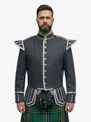 Man wearing a dark grey jacket with silver buttons and a irish national tartan plaid kilt on a white background