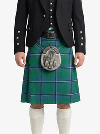Person wearing a green tartan kilt with a black jacket on a white background
