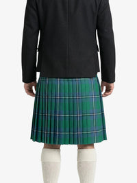 Person wearing a green plaid kilt with a black jacket on a white background