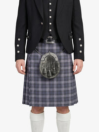 Person wearing a traditional Scottish kilt with a sporran on a white background