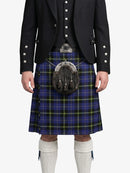 Person wearing a traditional Scottish kilt with a jacket on a white background