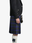 Person wearing a dark jacket and blue plaid kilt on a white background