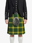 Person wearing a green and yellow plaid kilt with a black jacket on a white background