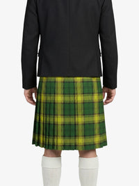 Person wearing a green plaid kilt with a black jacket on a white background