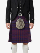 Person wearing a traditional Scottish kilt with a tartan pattern on a white background