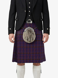 Person wearing a traditional Scottish kilt with a tartan pattern on a white background