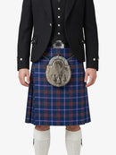 Person wearing a traditional Scottish kilt with a jacket on a white background