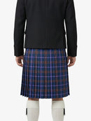Person wearing a black jacket and blue plaid skirt on a white background