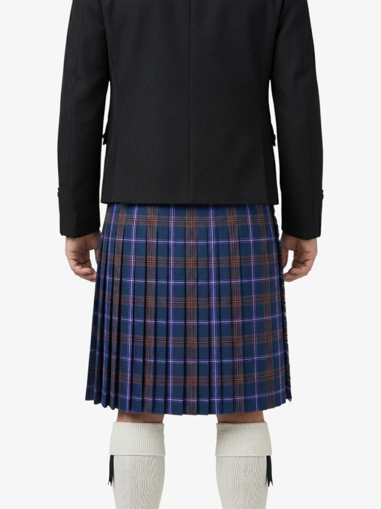 Person wearing a black jacket and blue plaid skirt on a white background