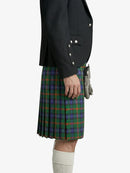 Person wearing a black jacket and green plaid kilt on a white background