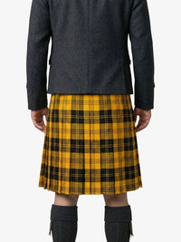 Person wearing a yellow and black plaid kilt with a dark jacket on a white background