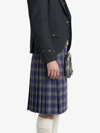Person wearing a dark gray jacket and blue plaid kilt on a white background
