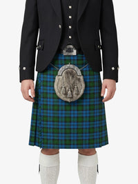 Person wearing a black jacket, blue plaid kilt, and white knee-high socks on a white background