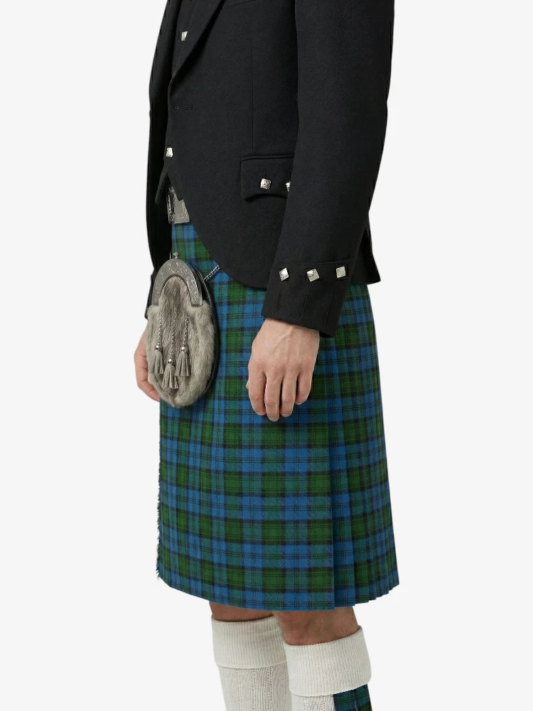 Person wearing a black jacket and blue plaid kilt on a white background