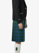 Person wearing a black jacket and green plaid kilt on a white background