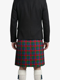 Person wearing a black jacket and a red, green, and blue plaid kilt on a white background